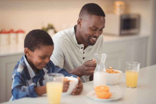 Father and son eating cereal