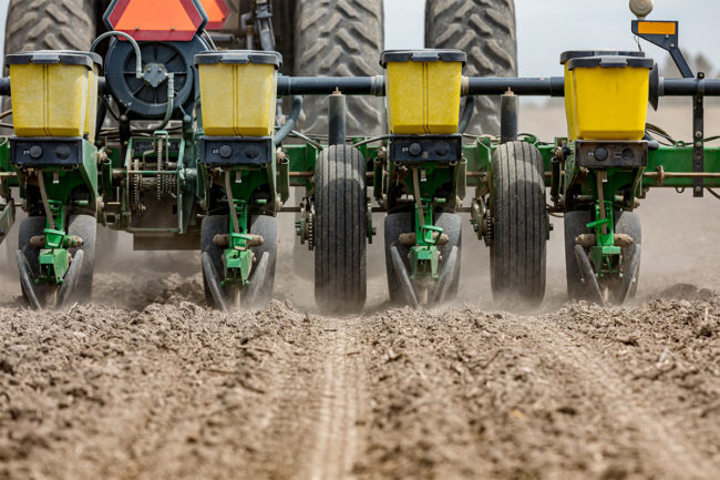 Tractor planters in a field