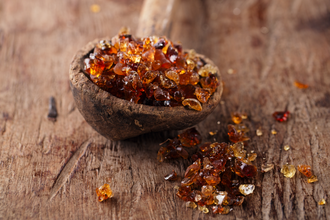 Gum arabic, also known as acacia gum - in old wooden spoon